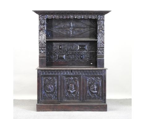 A 19th century dark oak dresser, relief carved with portrait medallions, 121cm