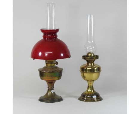 A brass oil lamp, with a glass shade, 60cm high, together with another
