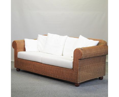 A wicker Lakeland sofa, 204cm, together with a pair of matching armchairs, all with loose cushions