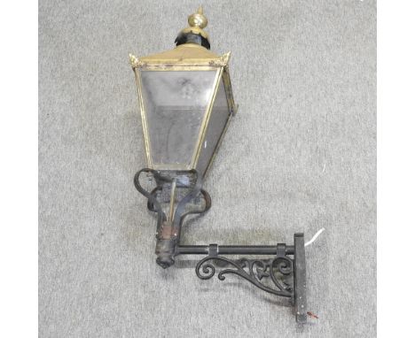 A brass lantern, mounted on a wrought iron bracket, 97cm high