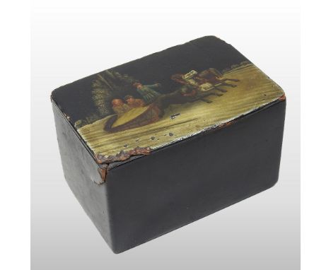 An early 20th century Russian black papier mache table cigarette box, the hinged lid decorated with traditional winter figure