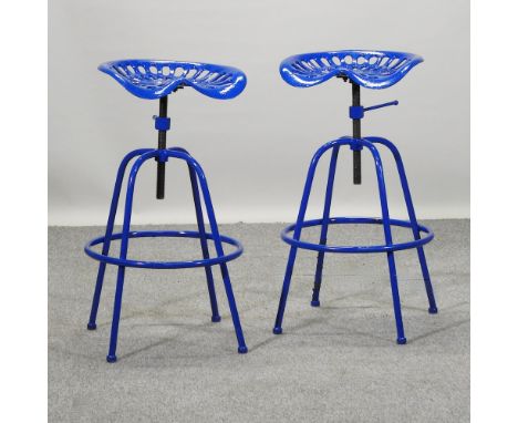 A blue painted tractor seat stool, together with another