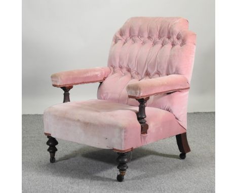 A Victorian pink upholstered button back armchair