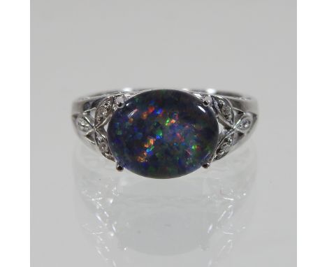 A 9 carat white gold opal ring, boxed