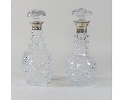 A cut glass decanter with a silver collar, together with another similar, 29cm high