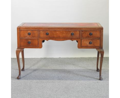 A Queen Anne style writing desk, with a red inset writing surface, on cabriole legs, 118cm