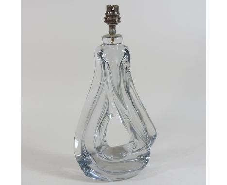 An early 20th century heavy glass lamp base, of abstract form, 35cm high overall