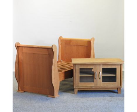 A cherrywood child's bed, together with a light oak cabinet, 91cm (2)
