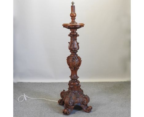 An ornate Italian style carved oak standard lamp, with a revolving top, 172cm high