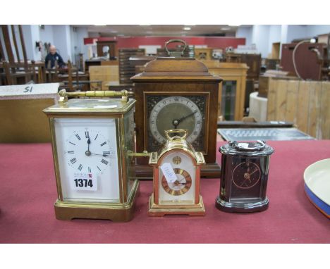 A Brass Carriage Clock, (back door loose), three other clocks.