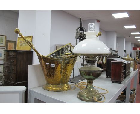 A Brass Oil Lamp, converted to electric, brass log bucket, fire irons, ship design trivet.