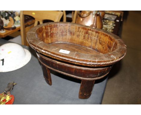 An antique Chinese wooden basin raised on four supports