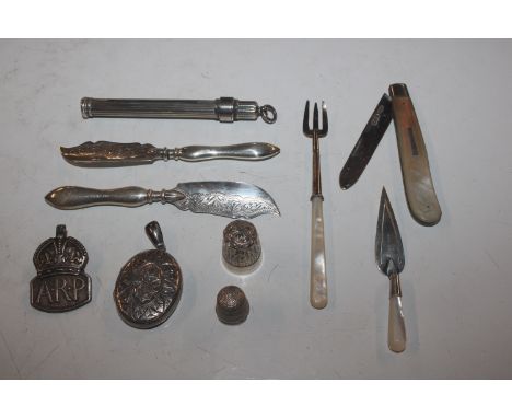 A box containing silver thimbles, a silver bladed fruit knife with mother of pearl handle; a silver ARP badge; a silver book 