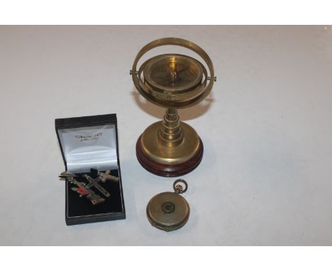A brass compass on wooden stand; and a Neva gold plated pocket watch etc.