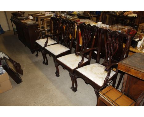 A mahogany twin pillar dining table with one extra leaf and a of eight Chippendale revival chairs, comprising of two carvers 