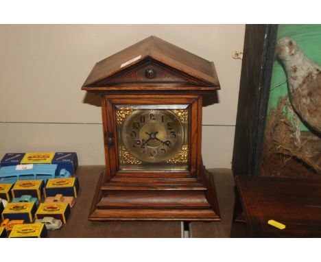 An oak cased German mantel clock with eight day movement