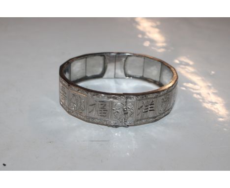 A white metal snap bangle (tested) containing silver, gold and palladium marked 18K, approx. total weight 40gms 