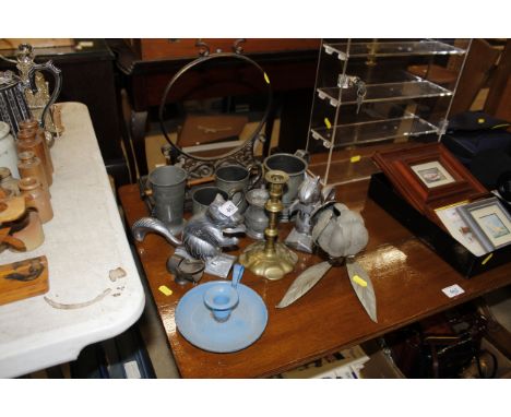 A pair of squirrel nut crackers; a pewter tankards; brass candlestick and enamel chamber stick 