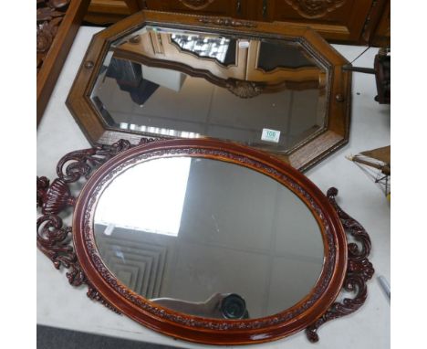 Oak framed bevel edged mirror: and similar later item 