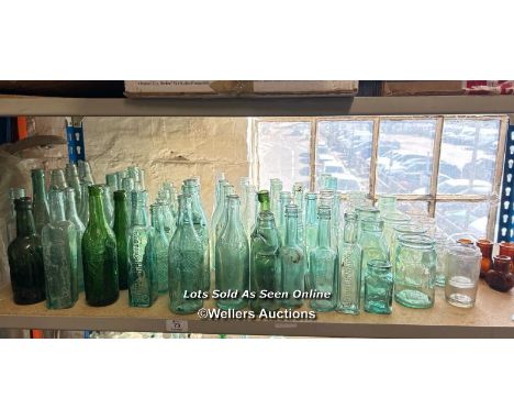 A very large collection of assorted vintage glass bottles and jars including R Whites, Bovril, Carlton's HP Sauce, Allen &amp
