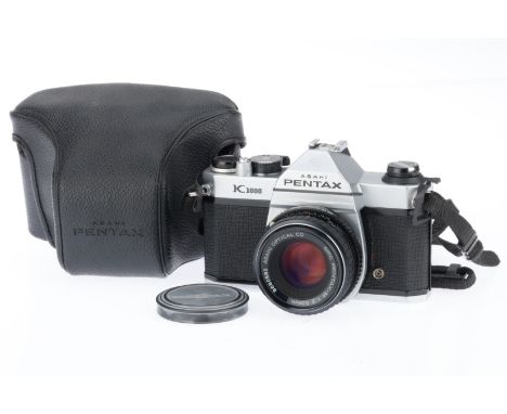 A Pentax K1000 35mm SLR Camera, silver, serial number 7721302, body VG, shutter works, meter needle responds, with an smc Pen