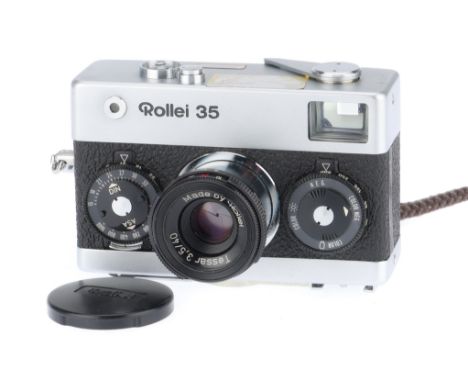 A Rollei 35 Compact Camera, silver, body G, shutter works, advance works, with soft cap.