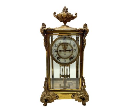 American - Ansonia 8-day brass cased four glass clock c1910, surmounted with a rococo style urn and castings to the top of th