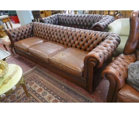 3 seater brown leather Chesterfield sofa - Tear in one cushion - Approx L: 235cm