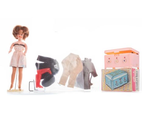 ORIGINAL SINDY DOLL IN NIGHTDRESS,presented on branded stand, together with a range of outfits and accessories including pink