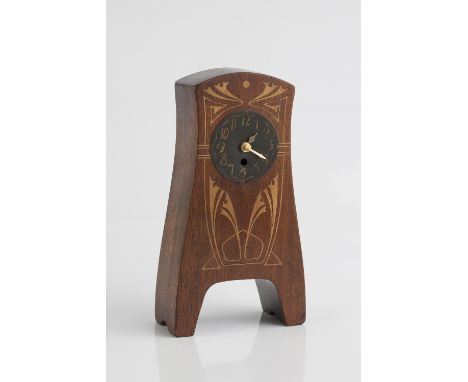 Art Nouveau Oak mantel clock inlaid with sinuous linear design and metal dial with Arabic numerals 25cm high.