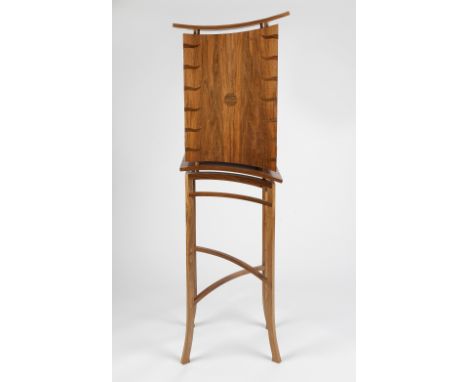 Derek Elliott (British, Contemporary) Standing walnut cabinet of pagoda form, inlaid cupboard doors opening to reveal shelf w