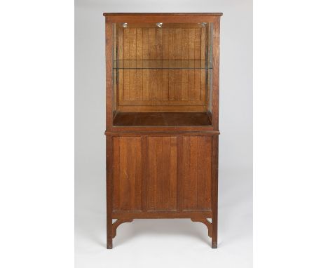 Hugh Birkett (British, 1919-2002) Cotswold School oak display cabinet the lower half with panelled front and sides, the upper