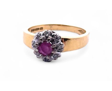 An 18ct gold, ruby and diamond cluster ring. Size N. Weight 4.88g.