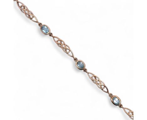 Topaz and 9ct gold bracelet, set with 4 oval topazes between Celtic knot style links. Length 20cm.