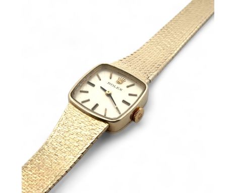 Rolex - a ladies 14ct gold watch on a 14ct gold bracelet. Rounded square champagne dial with gold tone and black enamel baton