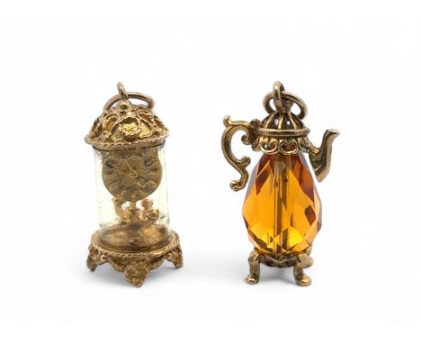 Two 9ct gold charms.  A charm in the form of a carriage clock, with original plastic outer casing,  hallmarked to base and st