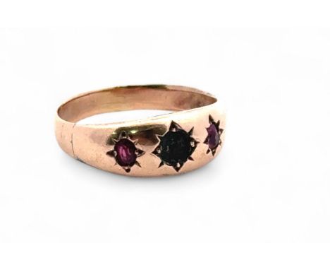 Gypsy ring with a ruby on either side of missing central stone size N. Weight 2.1g. Tests as 9ct gold using XRF.