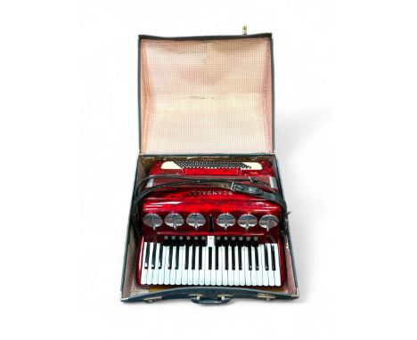 Scandalli bass 120 Barevetto Piano Accordion, in a polished patterned red finish. Comes with original leather straps and blue