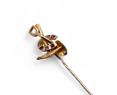 A miner's pin in the form of a pickaxe, shovel and a horseshoe set with ruby and diamonds. Main tests as 9ct using XRF, pin u