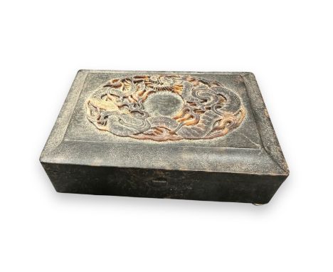 19th Century Chinese carved tortoiseshell snuff box with raised dragon decoration to lid. Stood on four ball feet (one missin