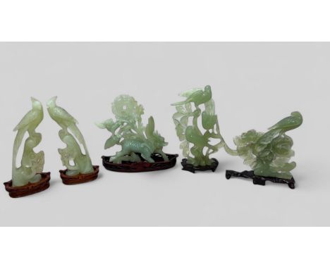 Five large jade carvings, boxed with wooden stands. Includes a carving of three birds amongst foliage, a dragon carving (repa