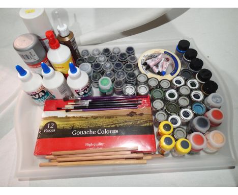Approximately fifty tinlets/jars of Humbrol/Airfix etc enamel/acrylic paints, plus brushes, glue, pencils, masking tape etc. 
