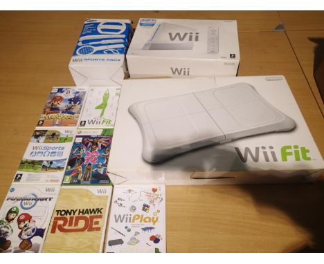 Nintendo WII with PSU, two pads with extension pads, sensor, TV cables, WII Fit and sports pack, all boxed. Power light comes