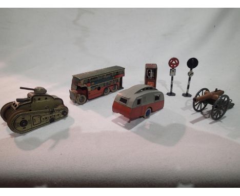 Gama clockwork sparking tank and a Wells clockwork bus, both good condition, untested, plus diecast Dinky caravan, and oil ca