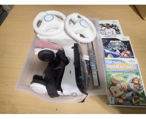 Nintendo WII, two controllers, wheels, headset, three boxed games and a sensor. No PSU, untested. UK P&amp;P Group 2 (£20+VAT