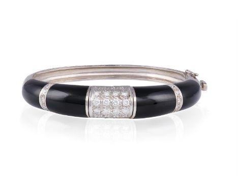 AN ONYX AND DIAMOND BANGLEThe hinged bangle, set to the front with graduated round brilliant-cut diamonds, interspersed by in