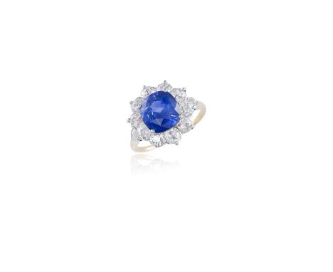 A SAPPHIRE AND DIAMOND CLUSTER RINGThe cushion-shaped sapphire, weighing approximately 5.00cts, within a frame of old brillia