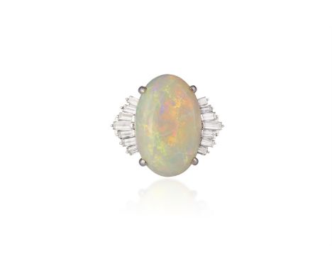 AN OPAL AND DIAMOND RINGThe oval-shaped opal cabochon, within a four-claw setting, between baguette-cut diamond shoulders, mo