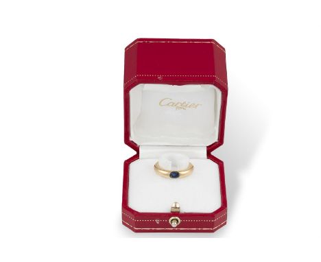 A SAPPHIRE 'ELLIPSE' RING, BY CARTIER, 1992The oval-shaped sapphire, set to a plain polished hoop, mounted in 18K gold, signe