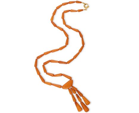 AN AMBER BEAD SAUTOIR NECKLACE The continuous graduated row of drop-shaped amber beads, suspending a tassel of similarly-shap